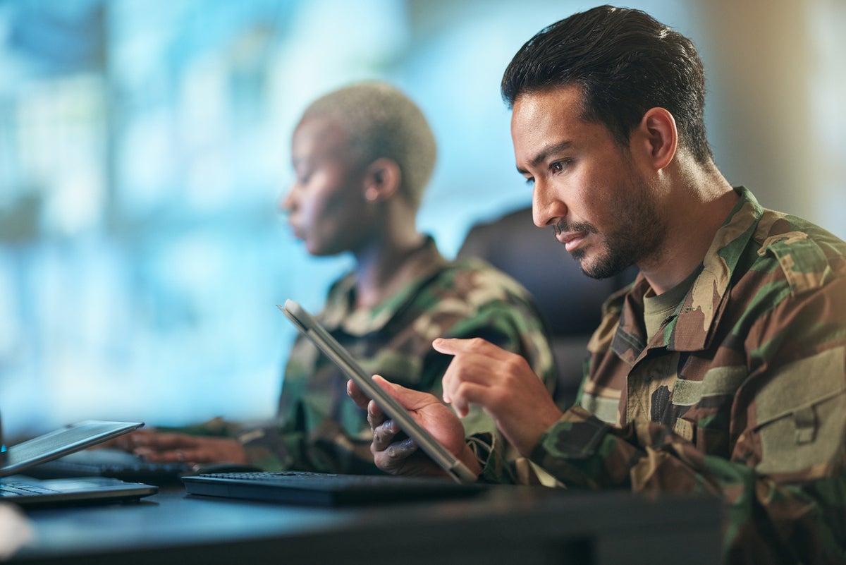 military people looking at tablet