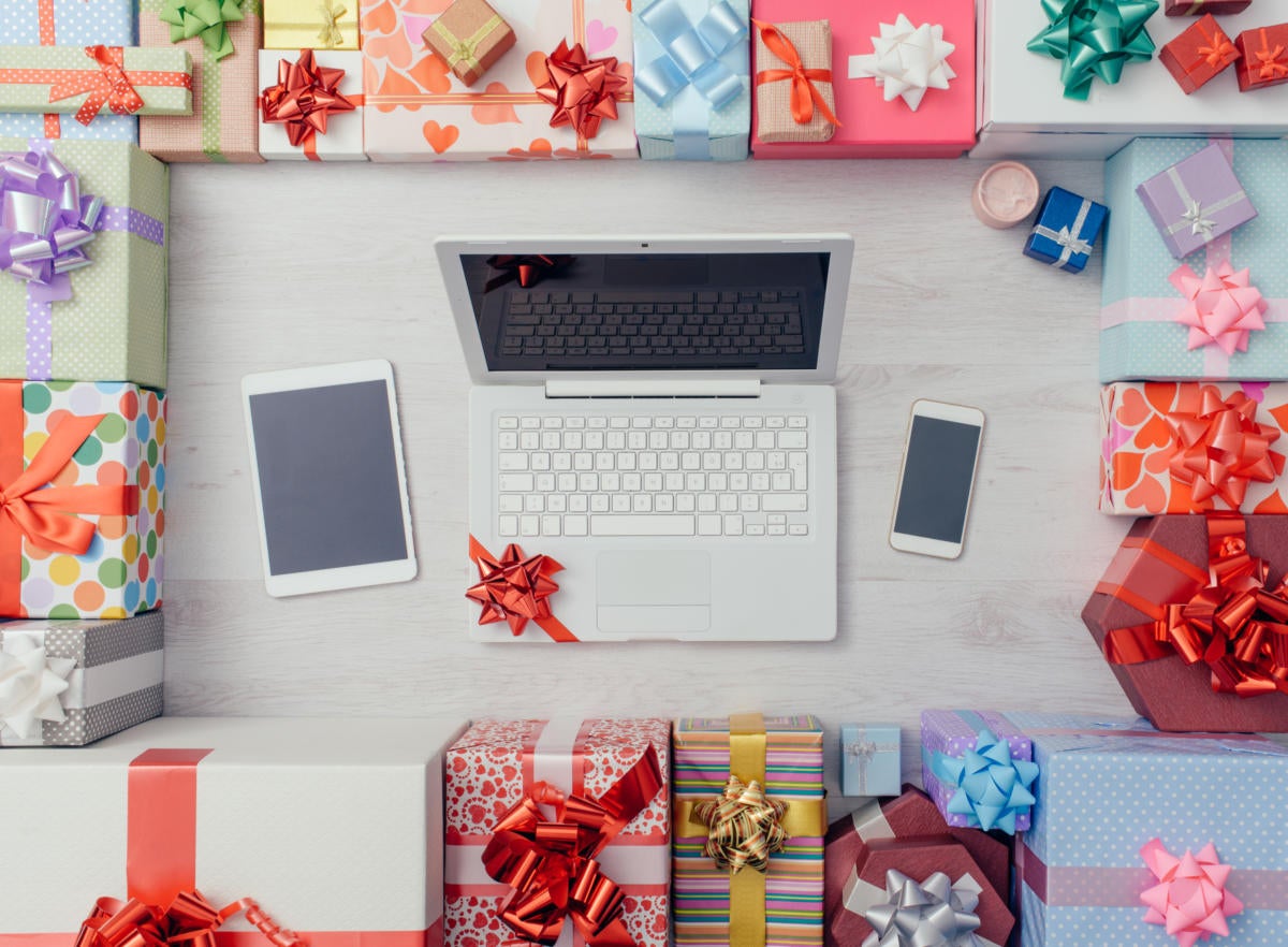 desk with laptop surrounded by gifts